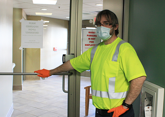 Maintenance staff cleans high touch areas in our offices