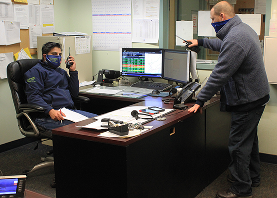 Dispatchers practice social distancing and wear masks